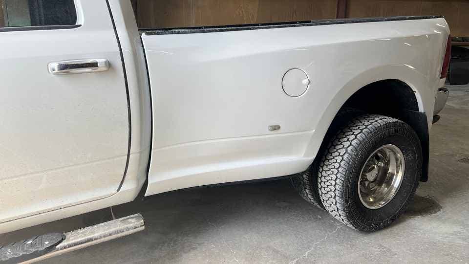 Before repair: Dented and heavily scraped truck bed and tailgate from work use