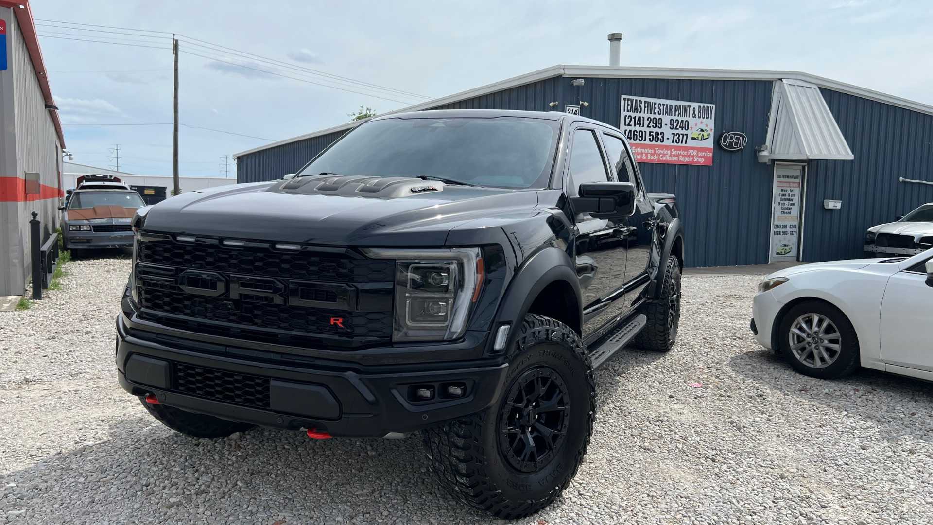 A black BMW sedan after complete auto body panel alignment.