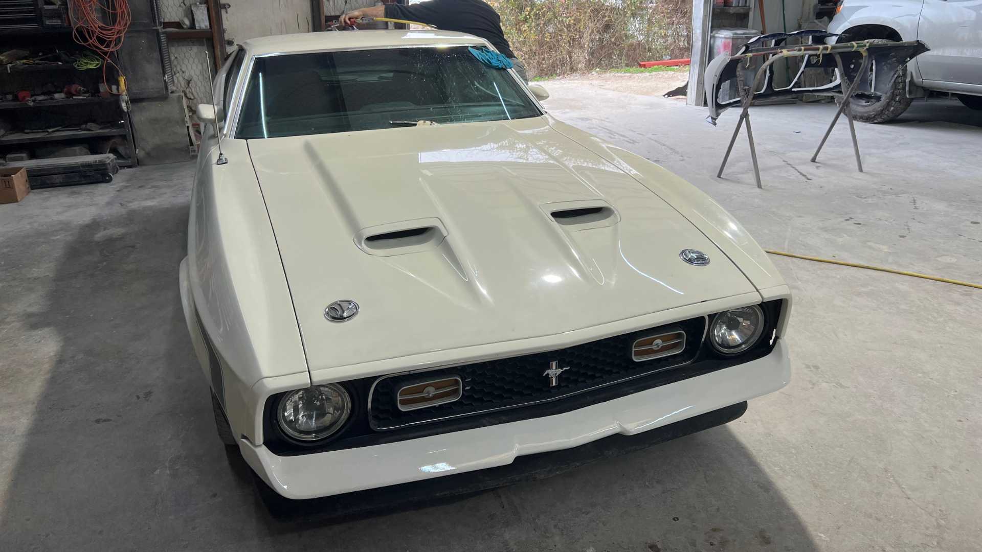 A luxury Maserati getting a final polish on its custom paint job.