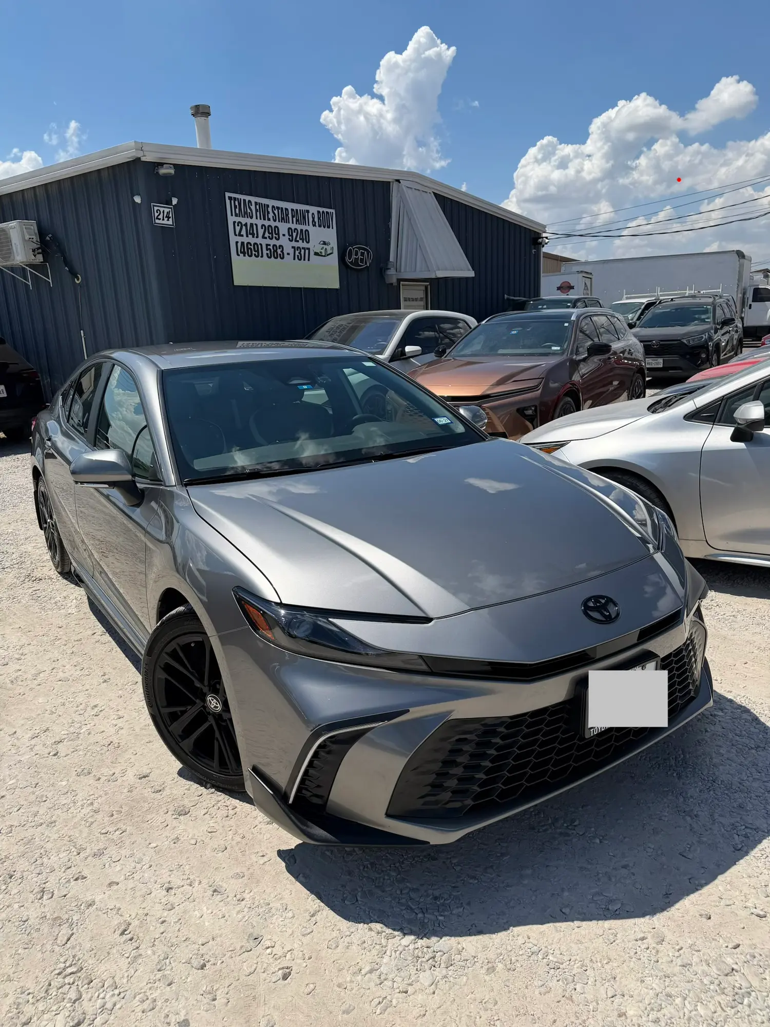 Gray Toyota Camry parked in front of the Texas Five Star Paint & Body shop