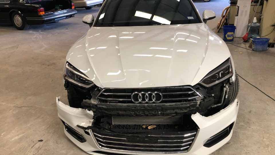 Before repair: Damaged frontend body panels, broken grille, and faded paintwork